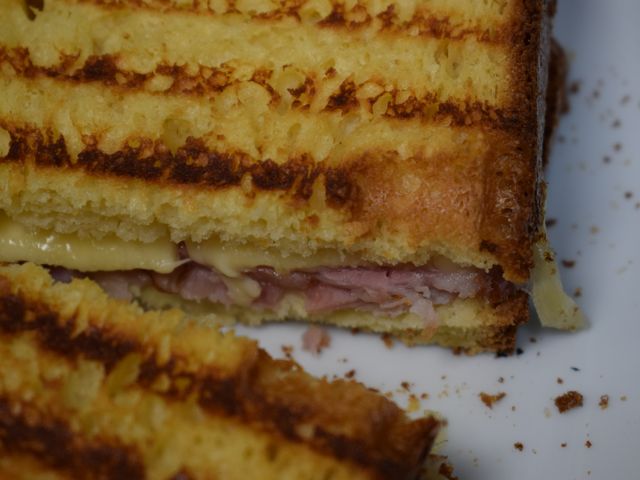 image of grilled ham and cheese on brioche with honey