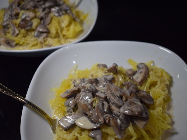 image of mushroom garlic cream sauce over a bowl of spaghetti squash