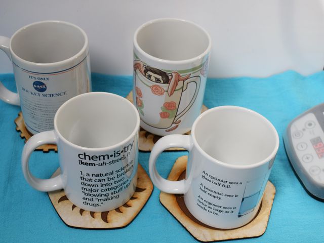 image of four laser cut coasters with mugs on them