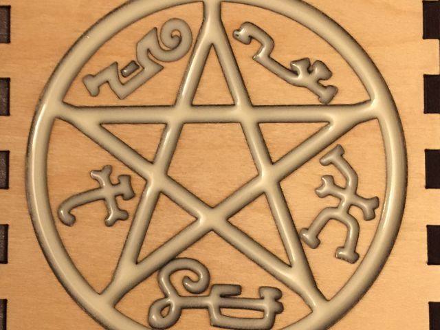 maple wood panel with resin filled symbol
