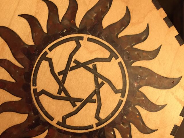 maple wood panel with resin and gem filled symbol