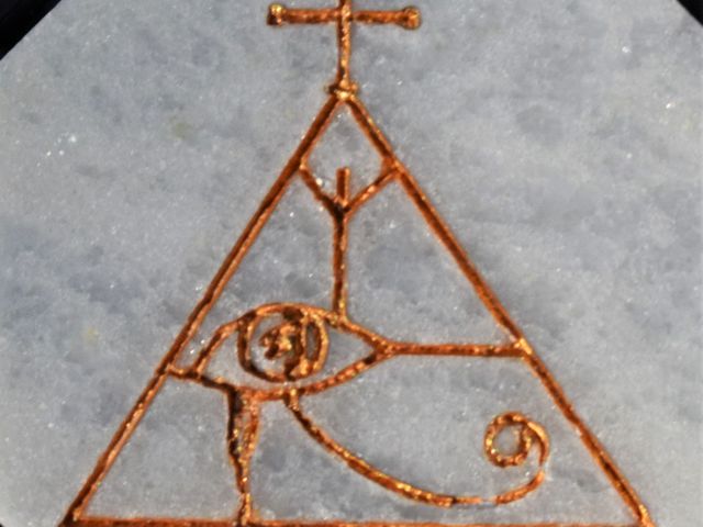 image of Egyptian Eye of Horus as used on Constantine, laser engraved into white marble and the lines filled with gold paint