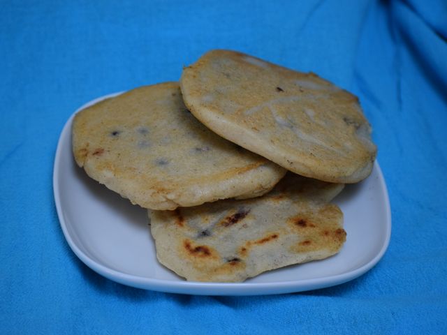 image of a plate piled with pupusas